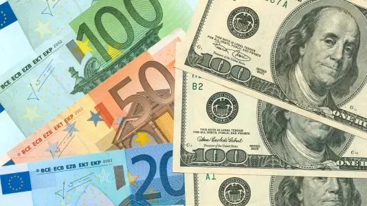 A side-by-side image of USD and Euro banknotes