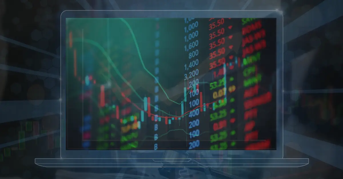 An image of a laptop overlayed with different elements of online trading to represent proprietary trading firms in South Africa