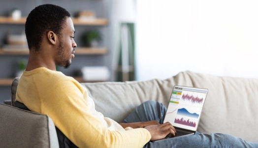 An image of a man monitoring the financial market for online trading